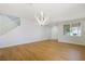 Bright living room featuring hardwood floors, a modern chandelier, and lots of natural light at 1371 Cumulus Ct, Henderson, NV 89014