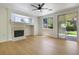 Bright living room featuring a fireplace, wood floors, and sliding glass doors for easy outdoor access at 1371 Cumulus Ct, Henderson, NV 89014