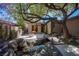 Beautiful backyard with pond, bridge, built-in grill, and fire pit, perfect for outdoor entertaining at 15 Emerald Dunes Cir, Henderson, NV 89052