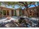 Backyard with pond, bridge, mature tree, and fire pit, creating a private oasis for relaxation and entertainment at 15 Emerald Dunes Cir, Henderson, NV 89052