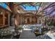 Idyllic backyard oasis featuring mature trees, a charming bridge, and a tranquil pond at 15 Emerald Dunes Cir, Henderson, NV 89052