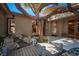 Luxury backyard with a serene pond, mature tree, and elegant outdoor seating areas, perfect for relaxation at 15 Emerald Dunes Cir, Henderson, NV 89052