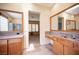 Bathroom featuring double sinks, granite countertops, and walk-in shower at 15 Emerald Dunes Cir, Henderson, NV 89052