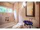 Elegant bathroom showcasing tiled walls, a blue vessel sink, and bathtub with shower at 15 Emerald Dunes Cir, Henderson, NV 89052