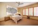 Relaxing bedroom featuring neutral walls, shutters, carpet, and an accent wall hanging above a cozy bed at 15 Emerald Dunes Cir, Henderson, NV 89052