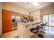 Bright kitchen with stainless steel appliances, light wood cabinets, and a granite countertop breakfast bar at 15 Emerald Dunes Cir, Henderson, NV 89052