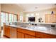 Open-concept kitchen with stainless steel appliances and a view of the living area at 15 Emerald Dunes Cir, Henderson, NV 89052