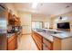 Modern kitchen with stainless steel appliances, granite countertops, a large island, and plenty of natural light at 15 Emerald Dunes Cir, Henderson, NV 89052