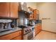 Kitchen features stainless steel appliances, wood cabinets, and a grey countertop at 15 Emerald Dunes Cir, Henderson, NV 89052