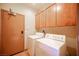 Functional laundry room with washer, dryer, and overhead storage cabinets at 15 Emerald Dunes Cir, Henderson, NV 89052