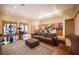 Spacious living room with skylights, wood floors, and an adjacent kitchen and dining area at 15 Emerald Dunes Cir, Henderson, NV 89052