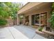 Spacious patio with stone pillars, seating, and a sliding glass door for seamless indoor-outdoor living at 15 Emerald Dunes Cir, Henderson, NV 89052