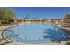 Resort-style swimming pool surrounded by mature trees and lounge chairs at 15 Emerald Dunes Cir, Henderson, NV 89052