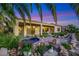 Expansive backyard with mature landscaping, a tranquil spa, and a covered patio area at 1637 Wellington Springs Ave, Henderson, NV 89052