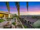 Scenic backyard view featuring an intricate stone pathway, colorful plants, and landscape at 1637 Wellington Springs Ave, Henderson, NV 89052