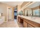 Primary bathroom featuring double sinks with a soaking tub and walk-in shower at 1637 Wellington Springs Ave, Henderson, NV 89052