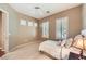 Cozy bedroom featuring neutral colors, plantation shutters, and a ceiling fan at 1637 Wellington Springs Ave, Henderson, NV 89052