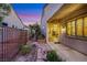 Exterior view of private side yard with mature landscaping, pathway, and patio at 1637 Wellington Springs Ave, Henderson, NV 89052