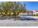 Charming single-story home with a three-car garage and mature trees in a well-maintained front yard at 1637 Wellington Springs Ave, Henderson, NV 89052