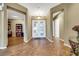 Inviting home foyer with wood floors, double doors, and access to adjacent rooms at 1637 Wellington Springs Ave, Henderson, NV 89052