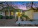 Charming single-story home exterior with desert landscaping, a walkway and double front doors at 1637 Wellington Springs Ave, Henderson, NV 89052