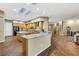 Gourmet kitchen with island, wood cabinets, granite countertops, and wood floors at 1637 Wellington Springs Ave, Henderson, NV 89052