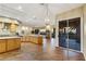 Large kitchen with wood cabinets, wood floors, a large island and mountain views at 1637 Wellington Springs Ave, Henderson, NV 89052