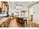 Bright kitchen featuring a central island, granite countertops, and wood look flooring at 1637 Wellington Springs Ave, Henderson, NV 89052
