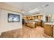 Open floor plan kitchen with granite counters, island seating, and stainless steel appliances at 1637 Wellington Springs Ave, Henderson, NV 89052