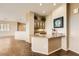 Open-concept living room featuring wood floors and a granite-topped wet bar with built-in cabinets at 1637 Wellington Springs Ave, Henderson, NV 89052