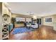 Comfortable living room with ceiling fan, wood floors, slider to covered patio, and exterior mountain views at 1637 Wellington Springs Ave, Henderson, NV 89052