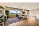 Spacious living room with hardwood floors, large windows offering scenic views, and stylish furnishings at 1637 Wellington Springs Ave, Henderson, NV 89052