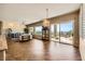 Expansive living room featuring hardwood floors, scenic views, and access to a covered outdoor patio at 1637 Wellington Springs Ave, Henderson, NV 89052