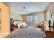 Main bedroom featuring neutral colors, shuttered windows, and carpeted floors at 1637 Wellington Springs Ave, Henderson, NV 89052