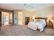 Spacious main bedroom featuring plush carpeting and views of the entrance and primary bathroom at 1637 Wellington Springs Ave, Henderson, NV 89052