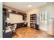 Home office with built-in desk, shelving, and wood look floors at 1637 Wellington Springs Ave, Henderson, NV 89052
