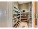 Walk-in pantry offers ample storage with adjustable shelves and tile floors at 1637 Wellington Springs Ave, Henderson, NV 89052