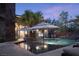 Inviting backyard pool with lounge chairs and umbrellas with manicured palm trees at 17 Soaring Bird Ct, Las Vegas, NV 89135