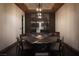 Formal dining room showcasing a large table set, unique light fixture, and wine display behind at 17 Soaring Bird Ct, Las Vegas, NV 89135