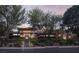 Stunning contemporary home with desert landscaping, warm lighting, and inviting staircase at 17 Soaring Bird Ct, Las Vegas, NV 89135