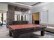 Spacious game room featuring a pool table, seating, and easy access to the outdoors at 17 Soaring Bird Ct, Las Vegas, NV 89135