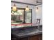 Kitchen view of a pool table, seating, and a bright, inviting outdoor area at 17 Soaring Bird Ct, Las Vegas, NV 89135