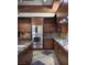 Modern kitchen boasts wood cabinetry, stainless steel appliances, and granite countertops at 17 Soaring Bird Ct, Las Vegas, NV 89135