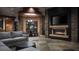 Modern living room with stacked stone accent walls, a fireplace, and a large-screen TV for cozy entertainment at 17 Soaring Bird Ct, Las Vegas, NV 89135