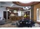 Open concept living room with an island bar, modern cabinets, and barstool seating at 17 Soaring Bird Ct, Las Vegas, NV 89135