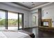 Spacious main bedroom with stone fireplace, dark wood floors, and private balcony access at 17 Soaring Bird Ct, Las Vegas, NV 89135