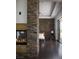 Contemporary main bedroom with stone fireplace and accent wall, dark floors, and sliding glass doors at 17 Soaring Bird Ct, Las Vegas, NV 89135