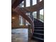 Elegant curved staircase featuring custom iron railing, stone accents, and natural light from surrounding windows at 17 Soaring Bird Ct, Las Vegas, NV 89135