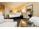 Inviting bedroom with seating area, desk and large bed with ensuite bath access at 2000 Fashion Show Dr # 5300, Las Vegas, NV 89109