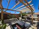 Backyard patio area complete with a pergola, comfortable seating, and a hot tub for relaxing at 2079 Port Royal Dr, Laughlin, NV 89029